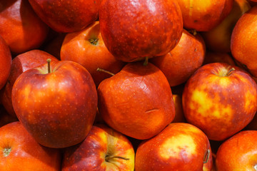 Fototapeta na wymiar Red fresh ripe apples close up in the supermarket. Fruits harvest. Food