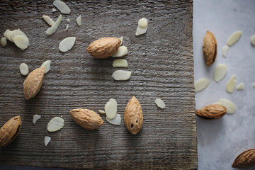 Unrefined and peeled almond on a wooden desk