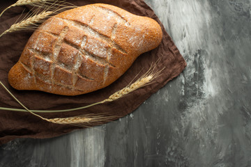 Delicious freshly baked bread on rustic background