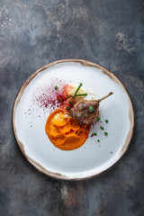 Duck leg confit with batat puree, carrots and couscous, restaurant meal, copy space