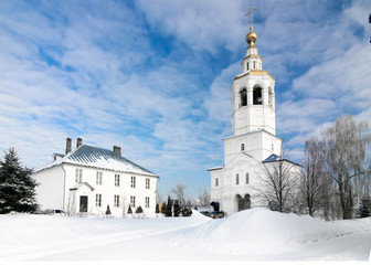 Fototapeta na wymiar Gate bell tower with the Church of Archangel Michael in Zilantov Svyato-Uspensky monastery.