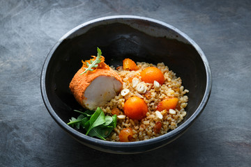 Baked turkey with bulgur, pumpkin, raisins and orange, copy space.