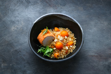 Baked turkey with bulgur, pumpkin, raisins and orange, copy space.