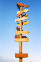 Wooden signposts against the blue sky