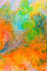 Fluid art. Abstract colorful background. Multicolored stains on liquid. Multicolored pattern with paints. Blurred background. Minimalism