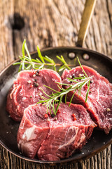 Close-up slices of beef tenterloin steak salt pepper and rosemary