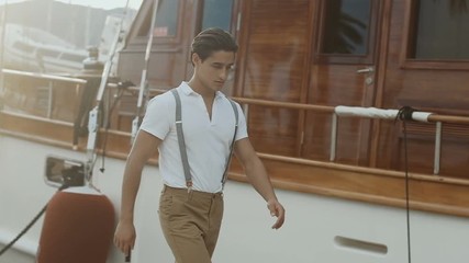 Portrait of Young Attractive stylish man against the hotels. Portrait of Male model. Slow motion
