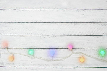 Christmas garland on a white wooden background.