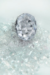 Beautiful large diamond engagement wedding ring sitting on multiple loose diamonds scattered throughout the background