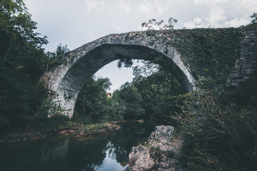 Stone bridge crosses a stream