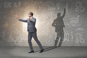 Businessman and his shadow in business concept