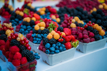 Fresh different berries in the plastic cup at Europe dong street berries and exotic fruits at...