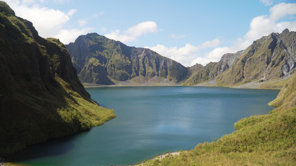 Fototapeta na wymiar Crater lake of the volcano Pinatubo among the mountains, Philippines, Luzon. Beautiful landscape at Pinatubo mountain crater lake. Travel concept
