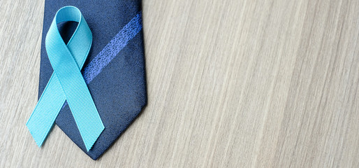 Prostate Cancer Awareness, light Blue Ribbon with necktie on wooden background for supporting...