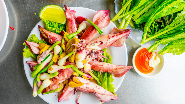 Vietnamese sea food, plate of steamed ginger sea squid, popular sea food of coastal people in Vietnam