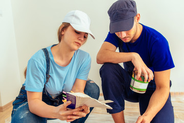 Man shows the right color for wooden furniture to his girlfriend