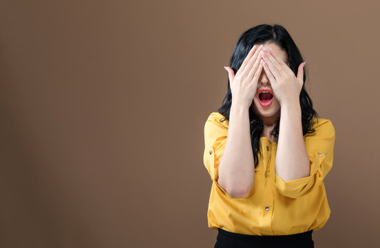 Young Woman Covering Her Eyes With Her Hands