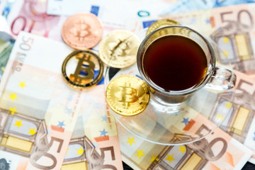 coins Bitcoin - crypto currency and traditional money. The choice of the modern world. Investments, cryptocurrency digital payment concept, various of bronze and golden bitcoins and cup of coffee.   