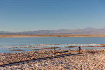 Atacama, Chile - Oct 9th 2017 - Tourists enjoying the sunset of the Atacama salar in a warm light,...