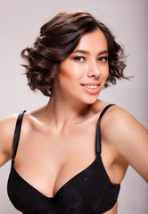 Naklejka premium Photo of beautiful sensual woman in black bra, showing face expression