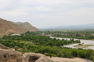 Fototapeta na wymiar View on the Kura river and Caucasus mountains from Ancient cave city Uplistsikhe, Georgia