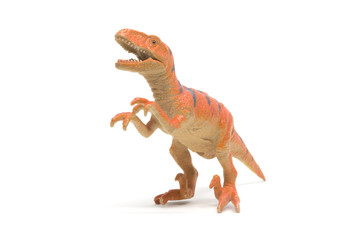 Naklejka premium Plastikowa zabawka velociraptor na białym tle