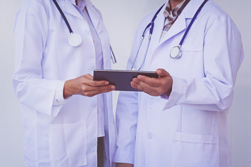doctors checking patient information on a tablet device