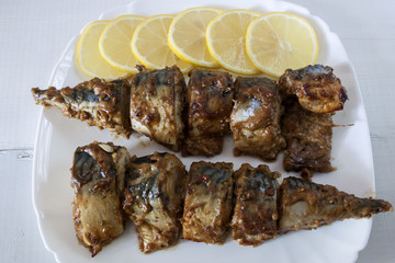 Marinated mackerel slices baked on the grill