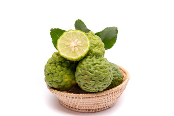 The kaffir lime leaves in the basket on a white background.