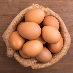 Fresh farm eggs on a wooden rustic background, Whipping eggs and whisk,top view with copy space