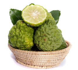The kaffir lime leaves in the basket on a white background.