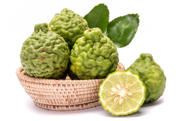 The kaffir lime leaves in the basket on a white background.