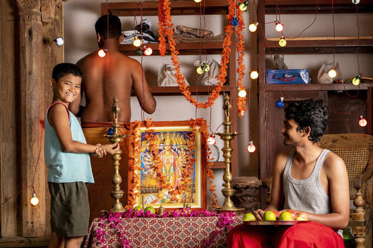 A group of young men prepare to worship at a Hindu Altar (Staged)