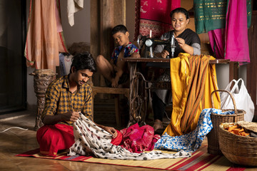 People work in a tailor shop (Staged)