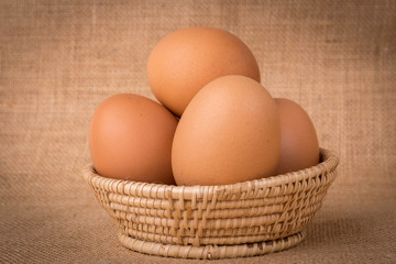 Eggs in a basket on  gunny (sackcloth)  background