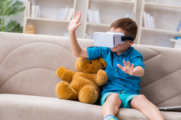 Young little boy with VR virtual reality glasses