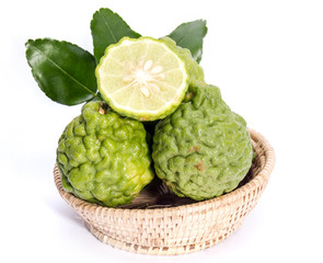 The kaffir lime leaves in the basket on a white background.