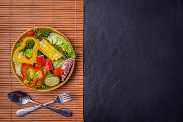 Salad healthy food on wood and black stone background. Weight loss. Copy space.