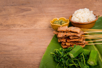 grilled pork or moo ping in Thai with sticky rice and Nam Prik Num (Northern Thai Green Chilli Dip)...