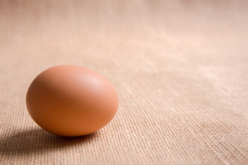 Fresh organic egg on sackcloth(gunny) with copy space for text