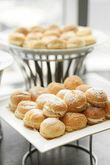 Choux cream. Profiteroles with lychee and fresh cream served at hotel’s coffee break