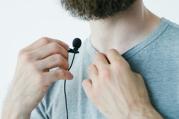 blogger preparing for video streaming.   man putting microphone on for quality sound. professional...