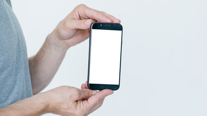 mobile payment. money transaction and orders. financial operations on the internet using digital devices. man holding smart phone with empty white screen on white background.