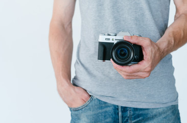 photography equipment. modern electronics technology for creative leisure. unrecognizable man holding photo camera in hands.