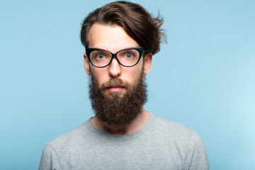 bearded hipster guy wearing cat eye glasses. stylish modern fashionist. portrait of a geeky quirky...