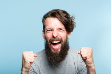 yes success and achievement. happy overexcited enthusiastic exhilarated guy making a win gesture...