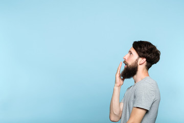 man looking sideways and is shocked or impressed by smth on the left. free space for advertisement...
