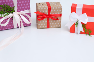 new year presents shopping. selection of wrapped gifts on white background. red purple and craft...