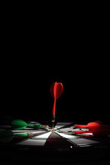 Target with arrow in the center on a black background