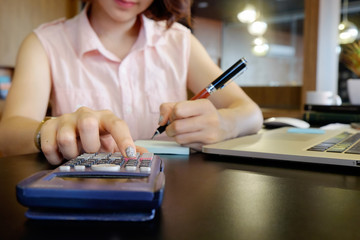 Business finance concept, cropped shot of female calculate of financial data with calculator.
